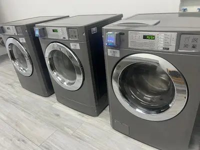 three washing machines are sitting next to each other at Disney Potter Condo FREE Shuttle & Parking in Orlando