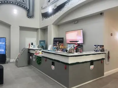 a lobby with a counter with christmas decorations on it at Disney 1st floorEpicShuttle in Orlando