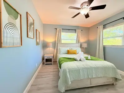 a bedroom with a bed and a ceiling fan at Spacious Orlando Stay Free Wifi Game Room in Orlando