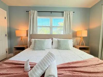 a bedroom with a large bed with two lamps at Spacious Orlando Stay Free Wifi Game Room in Orlando