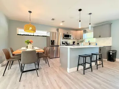a kitchen and dining room with a table and chairs at Spacious Orlando Stay Free Wifi Game Room in Orlando