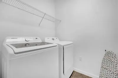 a white washer and dryer in a white room at Upstay Vibrant Home w Themed Rooms Pool & Games in Kissimmee