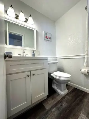 a bathroom with a toilet and a sink and a mirror at Welcome to Altamonte Springs! in Orlando