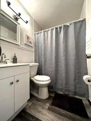 a bathroom with a toilet and a shower curtain at Welcome to Altamonte Springs! in Orlando