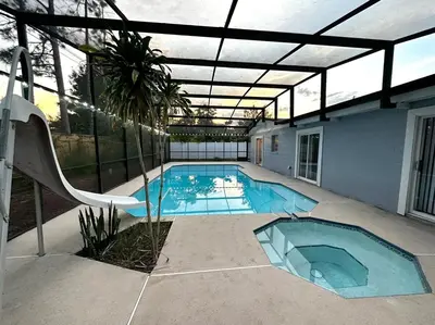 an indoor swimming pool with an open roof at Welcome to Altamonte Springs! in Orlando