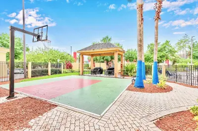 a basketball court with a gazebo and a basketball hoop at Peaceful King Bed Apartment w Hot Tub & Pool in Orlando