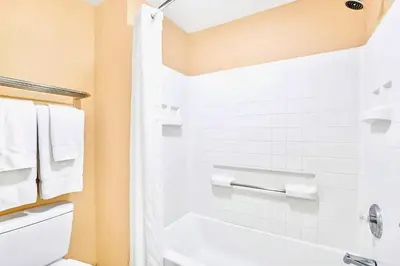 a bathroom with a white tub and a toilet at Peaceful King Bed Apartment w Hot Tub & Pool in Orlando