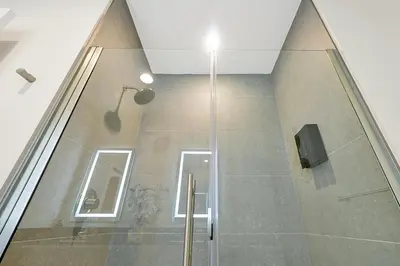 a shower stall in a bathroom with a window at Relaxing Nature Escapade with Game Room in Orlando