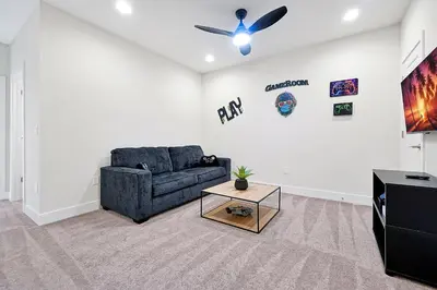 a living room with a couch and a ceiling fan at Relaxing Nature Escapade with Game Room in Orlando