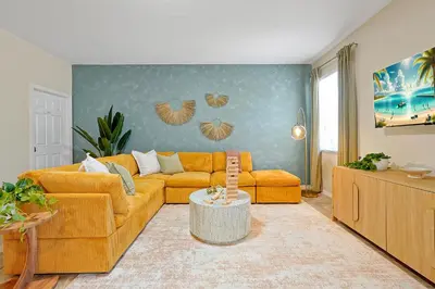 a living room with a couch and a table at 5BR Disney Villa with Private Pool & Spa in Kissimmee
