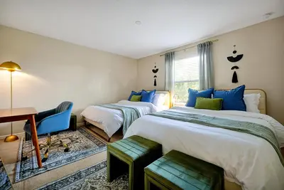 a bedroom with two beds and a desk and a table at 5BR Disney Villa with Private Pool & Spa in Kissimmee