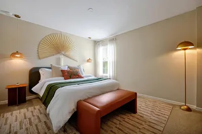 a bedroom with a large bed and a window at 5BR Disney Villa with Private Pool & Spa in Kissimmee