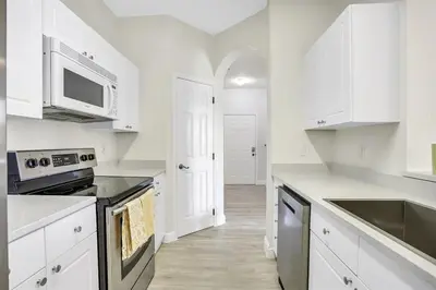 a kitchen with white cabinets and a stove top oven at 8102-3-PP-Vacation getaway condo at Windsor in Kissimmee