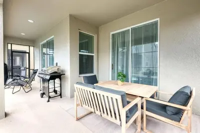 a dining room with a table and chairs and a piano at Casa de 6 Quartos no Storey Lake perto da Disney in Kissimmee