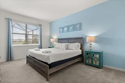 a bedroom with a large bed and a window at Summer Deal - Amazing 8BR Home with Private Pool! in Kissimmee
