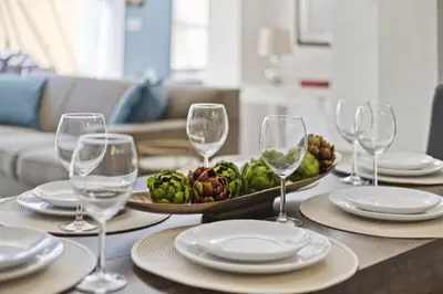 a table with wine glasses and a bowl of fruit at Cozy 3bd Townhouse Near Disney Encantada Resort in Kissimmee