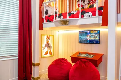 a childs room with red bean bag chairs and a table at Vibrant 5Bd w Private Pool & Waterpark at Storey Lake 4811M in Kissimmee