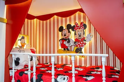 a bedroom with a mickey mouse mural on the wall at Vibrant 5Bd w Private Pool & Waterpark at Storey Lake 4811M in Kissimmee