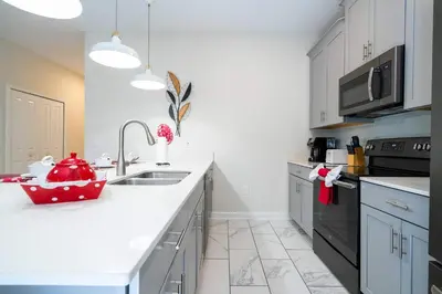 a white kitchen with a sink and a counter at Vibrant 5Bd w Private Pool & Waterpark at Storey Lake 4811M in Kissimmee