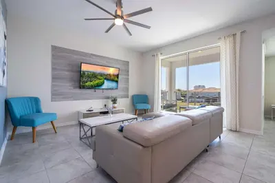 a living room with a couch and a table at Gorgeous 2Bd Close to Disney at Storey Lake Resort in Kissimmee