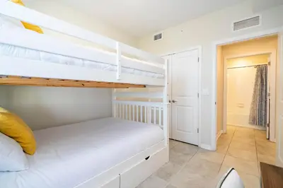 a bedroom with two bunk beds and a hallway at Family Condo 2Bd Close to Disney at Storey Lake Resort in Kissimmee