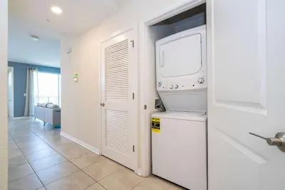 a kitchen with a washer and dryer in a room at Family Condo 2Bd Close to Disney at Storey Lake Resort in Kissimmee