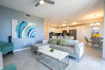 a living room with a couch and a table at Family Condo 2Bd Close to Disney at Storey Lake Resort in Kissimmee