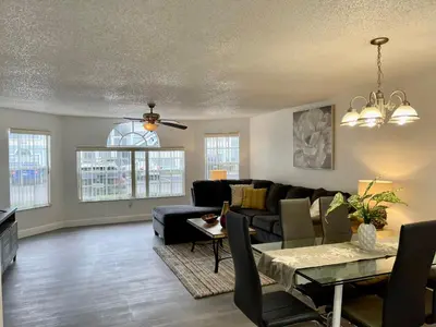 a living room with a couch and a table at Grand Superior 3BR Condo Apartment Near Disney Parks in Kissimmee