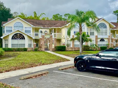a black car parked in front of a house at Grand Superior 3BR Condo Apartment Near Disney Parks in Kissimmee