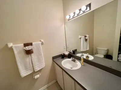 a bathroom with a sink and a mirror at Grand Emerald 3BR Townhouse Near Disney Parks in Kissimmee