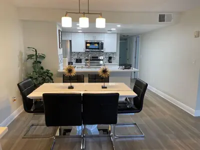 a dining room with a table and black chairs at Disney Superior 3BR Condo Near Theme Parks in Kissimmee
