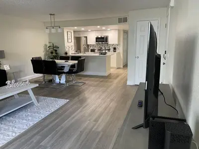 a living room with a dining room and a kitchen at Disney Superior 3BR Condo Near Theme Parks in Kissimmee