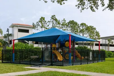 a playground with a blue tent in a park at King Room with Bathroom near Convention Center & Epic Universe in Orlando
