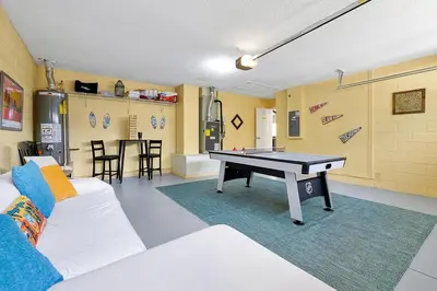 a living room with a ping pong table in it at 5BR Cottage w Pool & Hot Tub Near Disney in Kissimmee