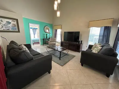 a living room with two couches and a television at Orlando Family 4BR | 10 Min to SeaWorld in Orlando