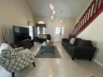 a living room with a couch and a table at Orlando Family 4BR | 10 Min to SeaWorld in Orlando