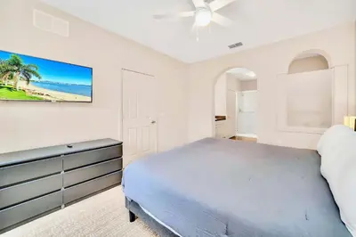 a bedroom with a bed and a ceiling fan at Condo with Pet-Friendly- Sauna & Pool in Orlando