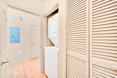 a kitchen with a door leading to a refrigerator at Condo with Pet-Friendly- Sauna & Pool in Orlando