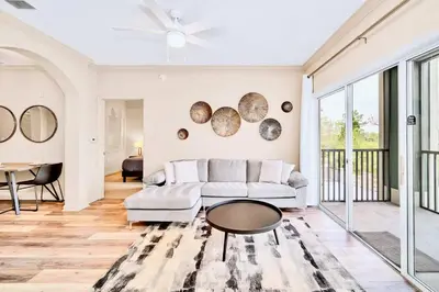 a living room with a couch and a table at Condo with Pet-Friendly- Sauna & Pool in Orlando