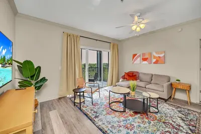 a living room with a couch and a table at Upstay - Condo - Hot Tub & Pool in Orlando