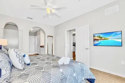 a white bedroom with a bed and a ceiling fan at Pet-Friendly - Upstay Condo w Pool Sauna in Orlando