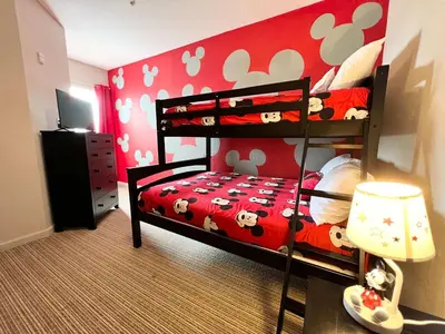 a bedroom with a bunk bed with mickey mouse wallpaper at Pet-Friendly - Upstay Condo w Pool Sauna in Orlando
