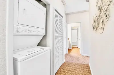 a white laundry room with a washer and dryer at Pet-Friendly - Upstay Condo w Pool Sauna in Orlando