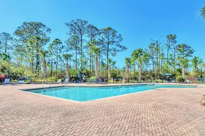 a swimming pool in a park with palm trees at Pet-Friendly - Upstay Condo w Pool Sauna in Orlando