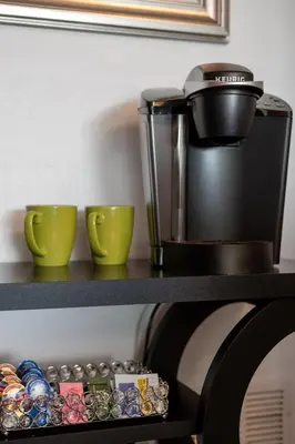 a coffee maker and two cups on a shelf at Fabulous Condo at World Quest Resort Disney area in Orlando