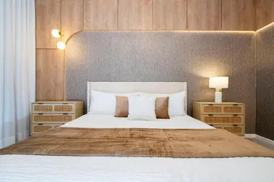 a bedroom with a large bed with white sheets and pillows at NEW Paradiso Grande Disney Themed Cinema5827 in Orlando