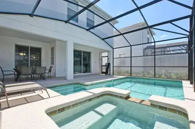 a swimming pool in a house with a glass ceiling at Casa 6 Quartos | Piscina Privativa | 10min Disney! in Kissimmee