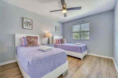 a bedroom with two beds and a ceiling fan at Stylish Townhome Close to Disney Parks in Kissimmee