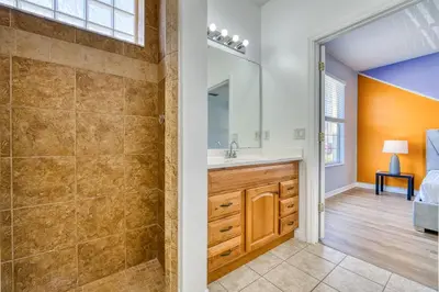 a bathroom with a shower and a sink at Stylish Townhome Close to Disney Parks in Kissimmee