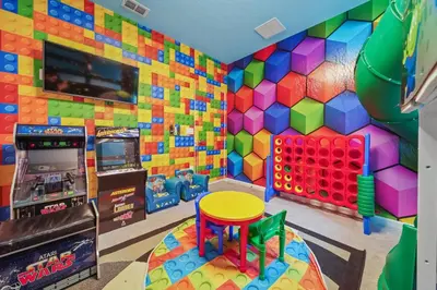 a childs room with a colorful wall and a table at The Bling Estate in Kissimmee